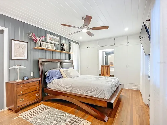 a bedroom with a bed and a chandelier