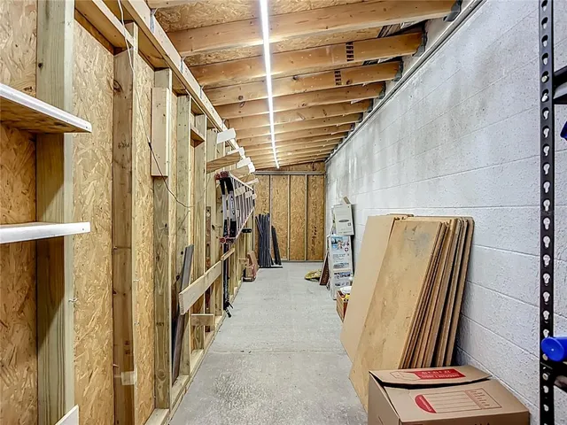 a room with stainless steel appliances lots of wooden furniture