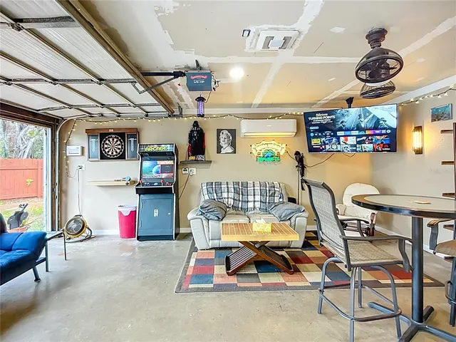 a view of house with sign board and a yard