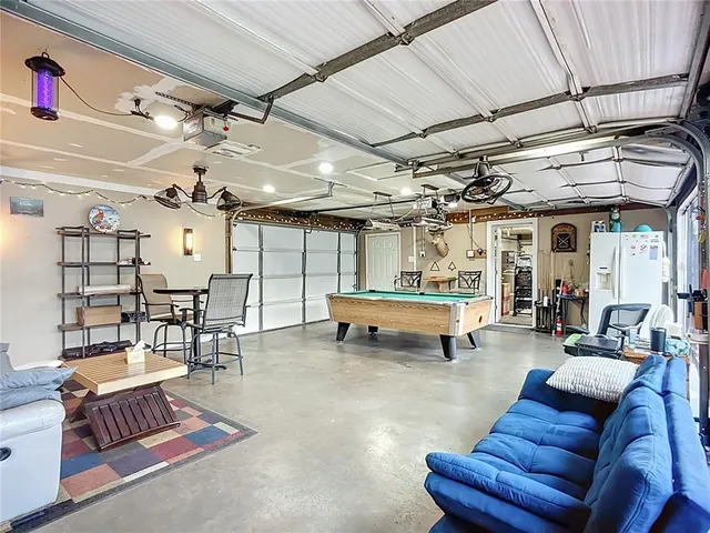 a view of a patio with a table chairs under an umbrella with wooden floor