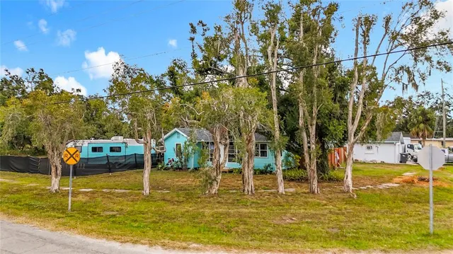 an aerial view of a house with a yard
