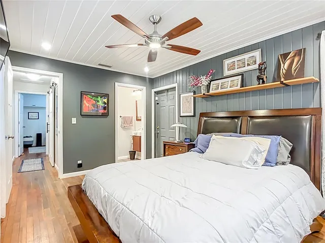 a bedroom with a large bed and a chandelier