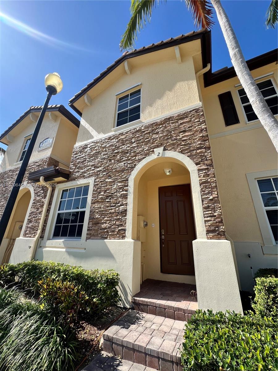 9031 Southwest 227th Street, Unit 2 Cutler Bay, FL 33190 - Photo 1 of 16 a front view of a house with a yard