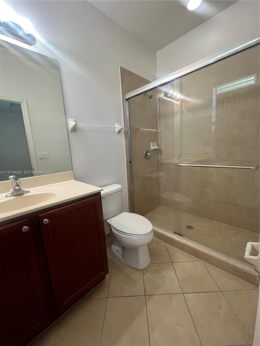 9031 Southwest 227th Street, Unit 2 Cutler Bay, FL 33190 - Photo 11 of 16 a bathroom with a sink a toilet and shower