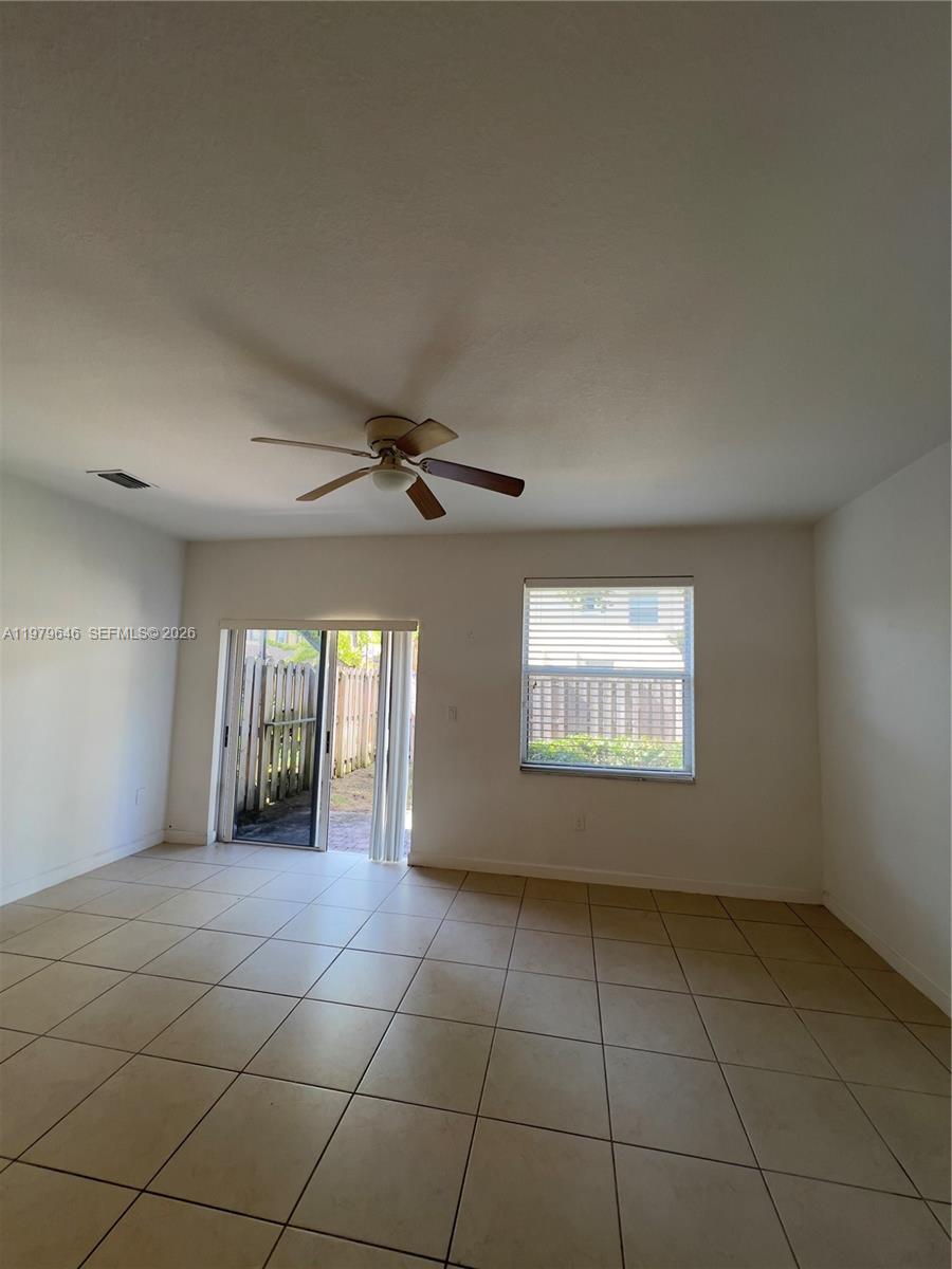 9031 Southwest 227th Street, Unit 2 Cutler Bay, FL 33190 - Photo 12 of 16 a view of an empty room and window