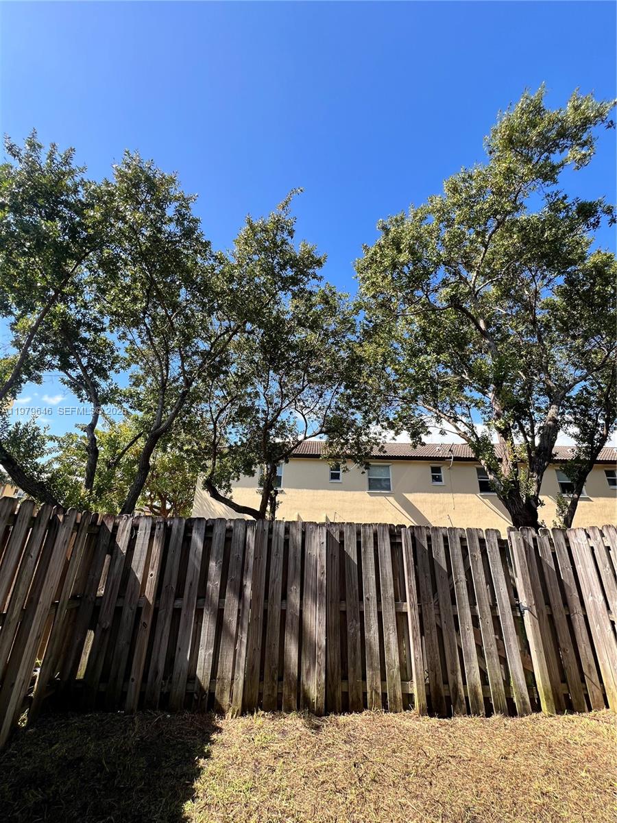 9031 Southwest 227th Street, Unit 2 Cutler Bay, FL 33190 - Photo 14 of 16 a view of deck with wooden floor and fence