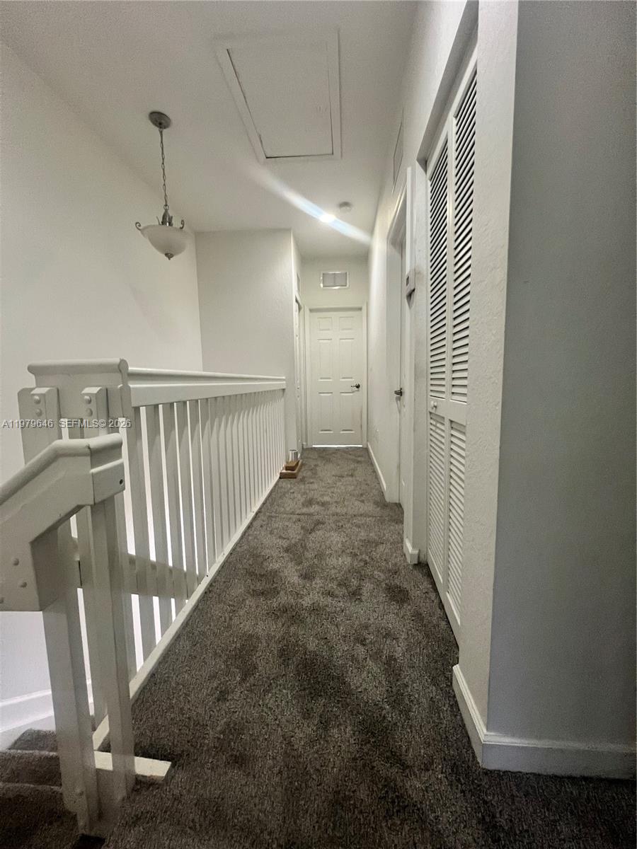 9031 Southwest 227th Street, Unit 2 Cutler Bay, FL 33190 - Photo 6 of 16 a view of a hallway with staircase