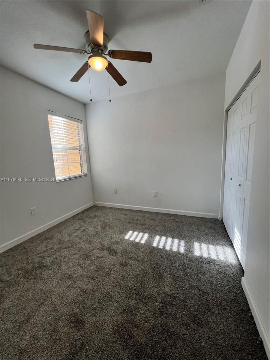 9031 Southwest 227th Street, Unit 2 Cutler Bay, FL 33190 - Photo 9 of 16 a view of an empty room and window