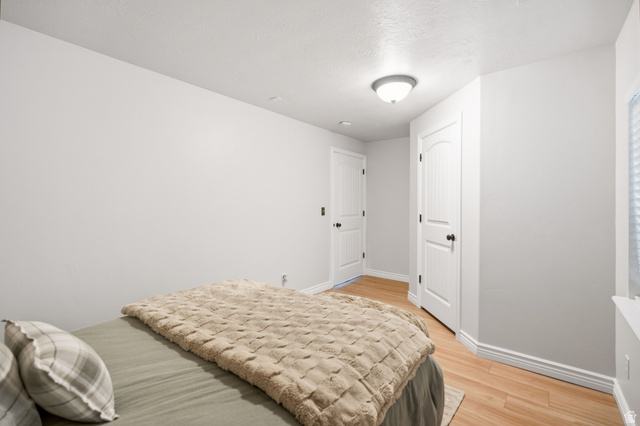 2029 West Crescent Row Mapleton, UT 84664 - Photo 20 of 28 Wood-finish flooring, white walls, and a ceiling-mounted light fixture