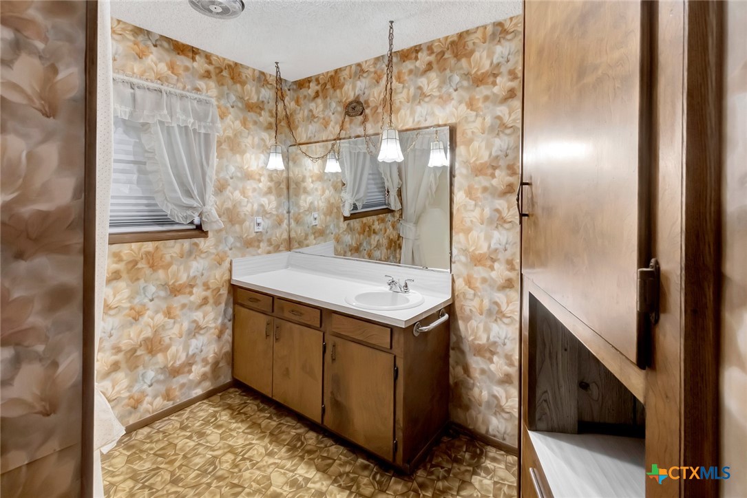 10957 Highway 77 Schulenburg, TX 78956 - Photo 11 of 35 a bathroom with a sink and a mirror