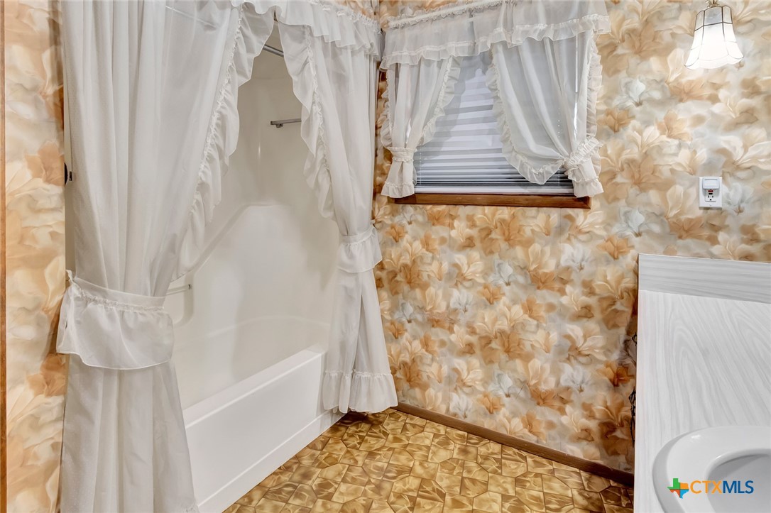 10957 Highway 77 Schulenburg, TX 78956 - Photo 12 of 35 a bathroom with a shower