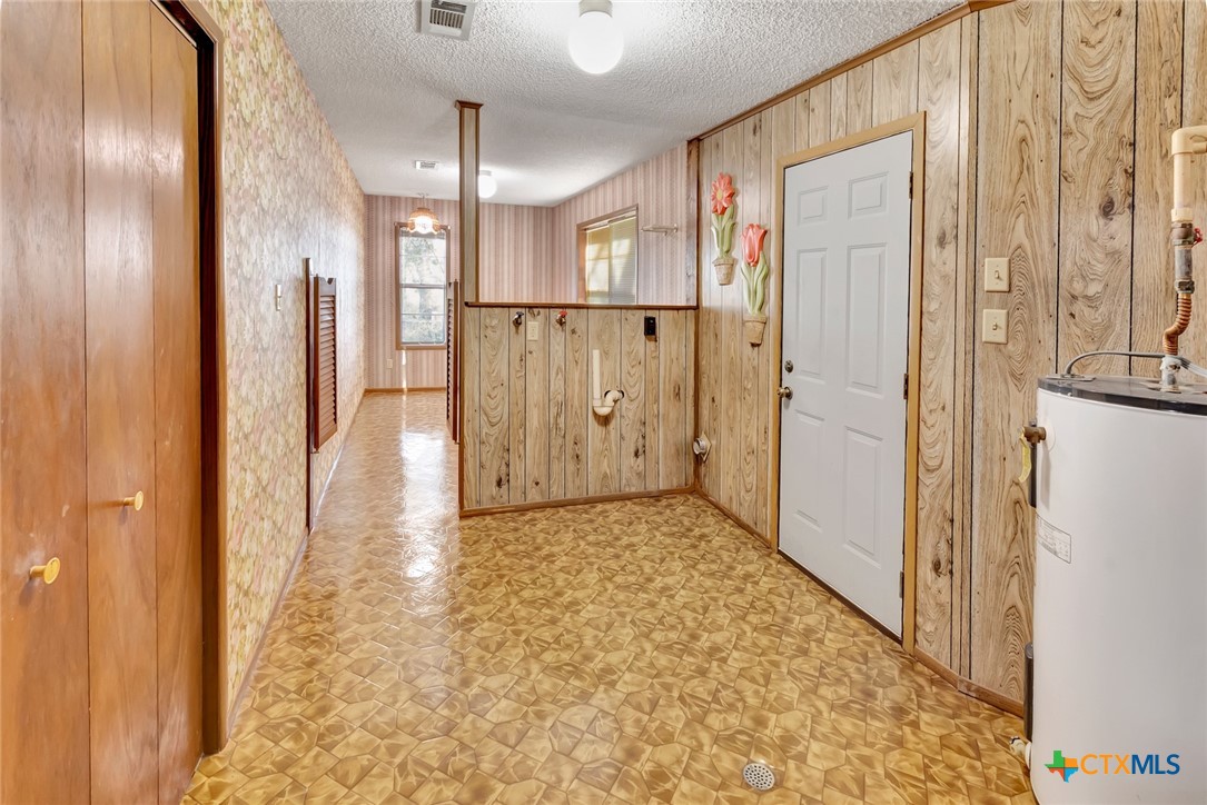 10957 Highway 77 Schulenburg, TX 78956 - Photo 13 of 35 a view of a hallway with wooden floor and staircase