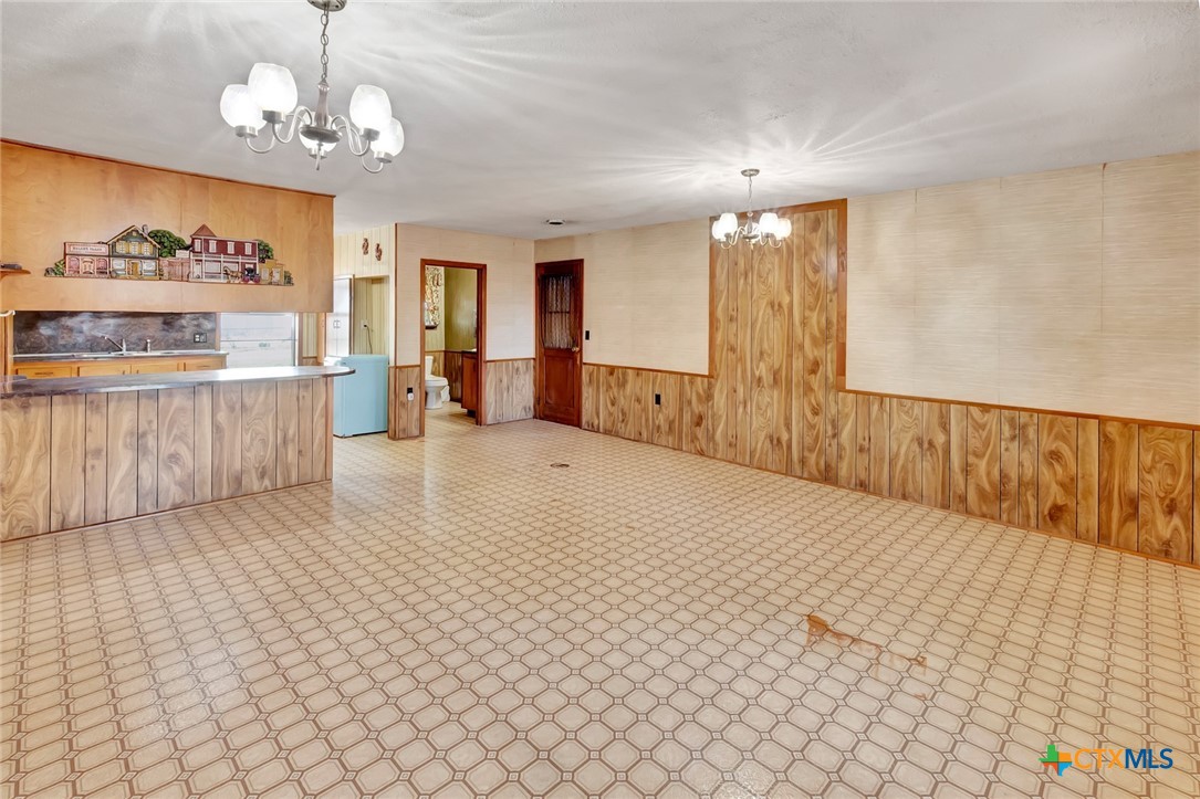 10957 Highway 77 Schulenburg, TX 78956 - Photo 20 of 35 wooden floor in an empty room with a window