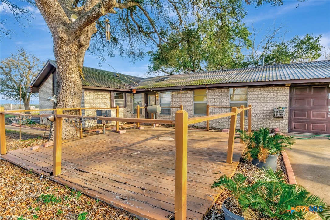 10957 Highway 77 Schulenburg, TX 78956 - Photo 27 of 35 a view of a patio with table and chairs potted plants and large tree