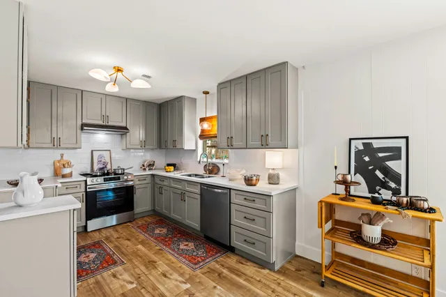 a kitchen with a sink appliances and cabinets