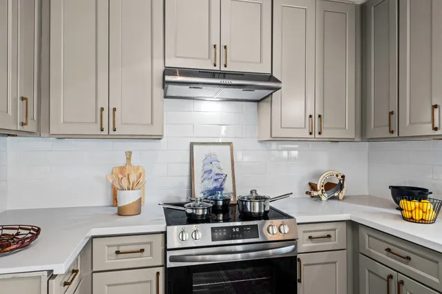 a kitchen with a stove and cabinets