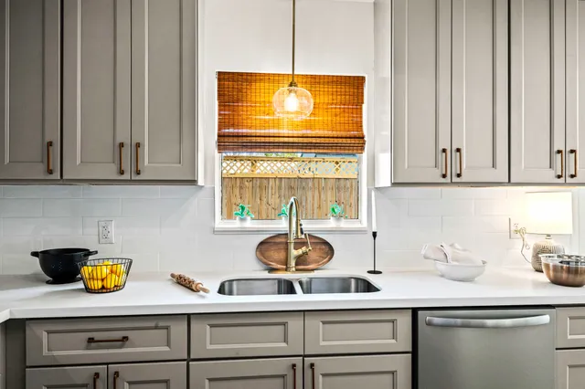 a kitchen with a sink cabinets and window