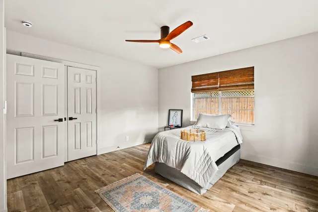 a bedroom with a bed and a window