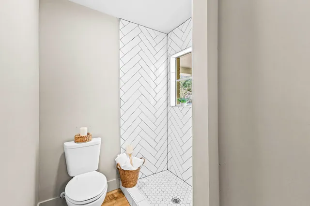 a white toilet sitting next to a shower curtain