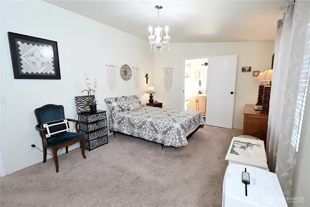a bedroom with furniture and a chandelier