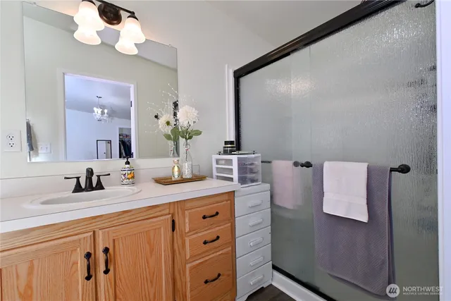 a bathroom with a sink vanity granite and a mirror