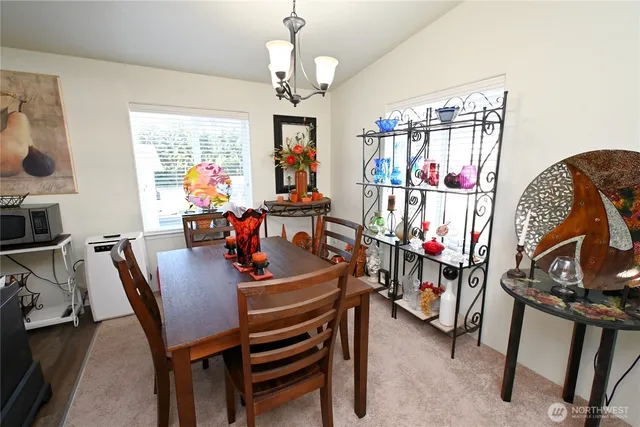 a view of a dining room with furniture and chandelier