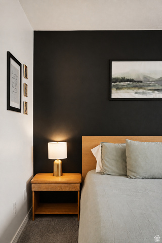 204 Lyman Lane Bountiful, UT 84010 - Photo 10 of 28 Accent wall with contrasting paint, wood-finish flooring, and a light wood headboard