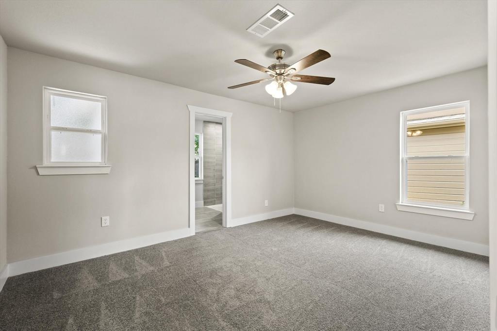 5629 Maceo Lane Fort Worth, TX 76112 - Photo 14 of 25 an empty room with windows and fan