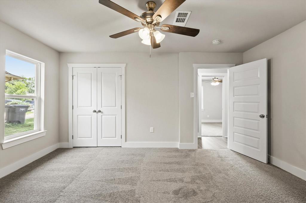 5629 Maceo Lane Fort Worth, TX 76112 - Photo 15 of 25 an empty room with windows and fan