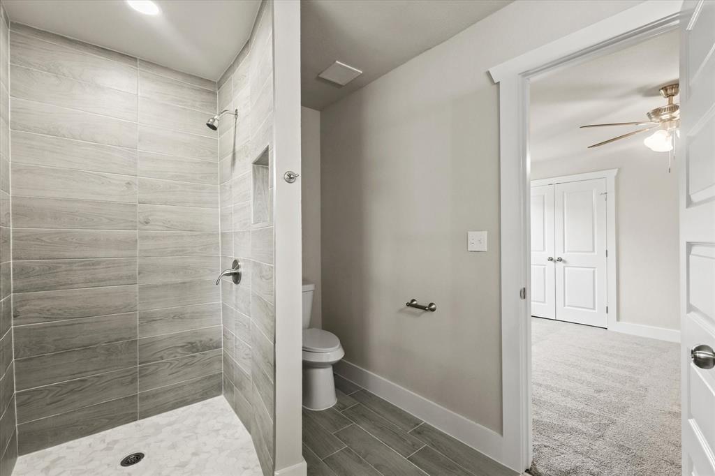 5629 Maceo Lane Fort Worth, TX 76112 - Photo 17 of 25 a bathroom with a shower and a toilet