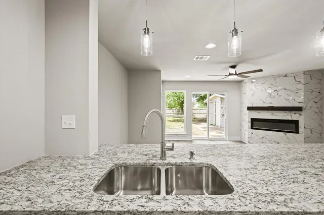 a kitchen with kitchen island a stove a sink and a counter space