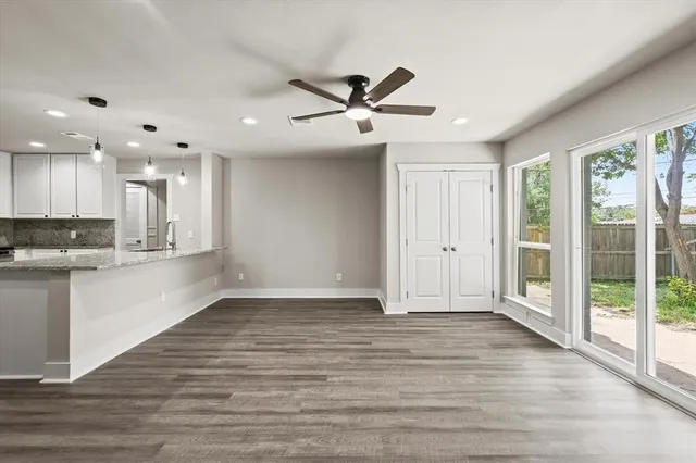 a view of an empty room with a kitchen