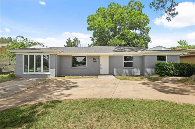 a house with trees in the background