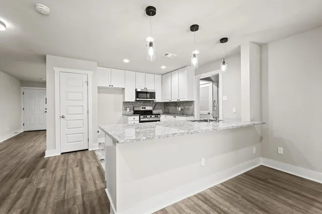 a kitchen with stainless steel appliances a refrigerator sink and cabinets