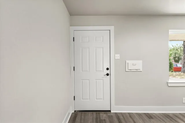 a view of an empty room and wooden floor
