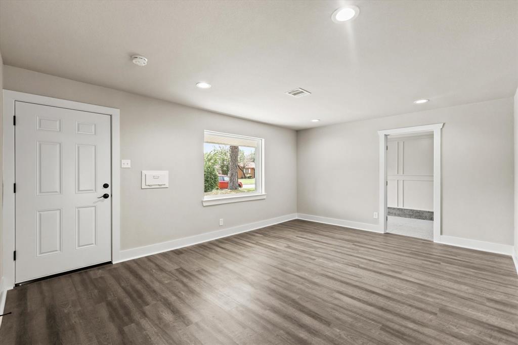 5629 Maceo Lane Fort Worth, TX 76112 - Photo 6 of 25 a view of an empty room with wooden floor and a window