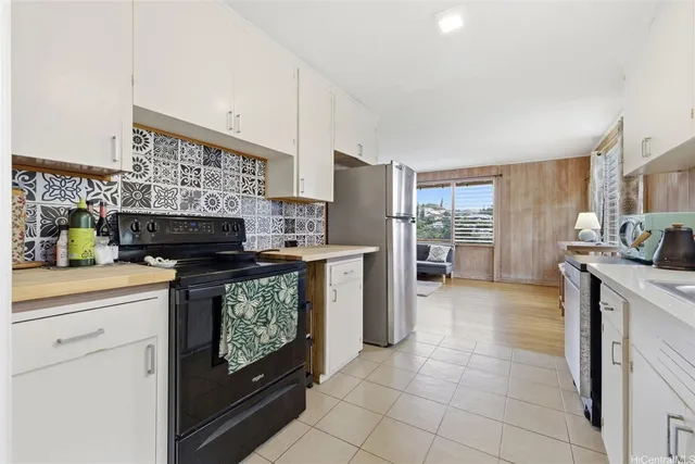 a kitchen with stainless steel appliances granite countertop a stove and a refrigerator