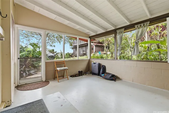 a room with wooden floor and outdoor seating