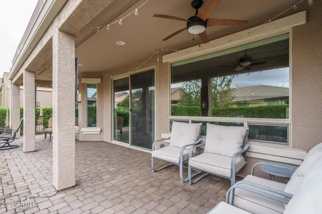 a view of a patio with table and chairs potted plants with wooden floor