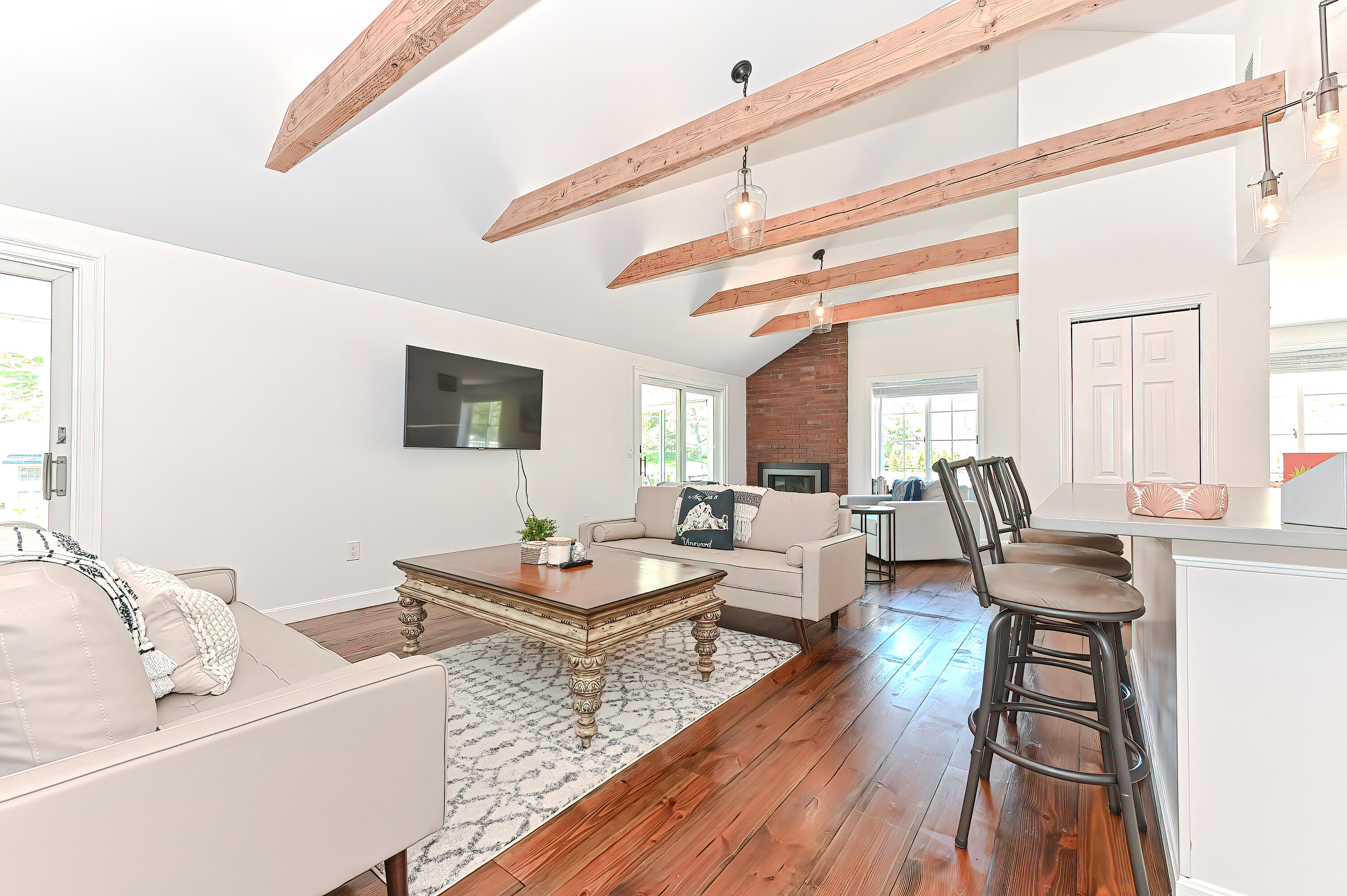 8 Cutlass Lane Mashpee, MA 02649 - Photo 3 of 93 a living room with fireplace furniture and a wooden floor