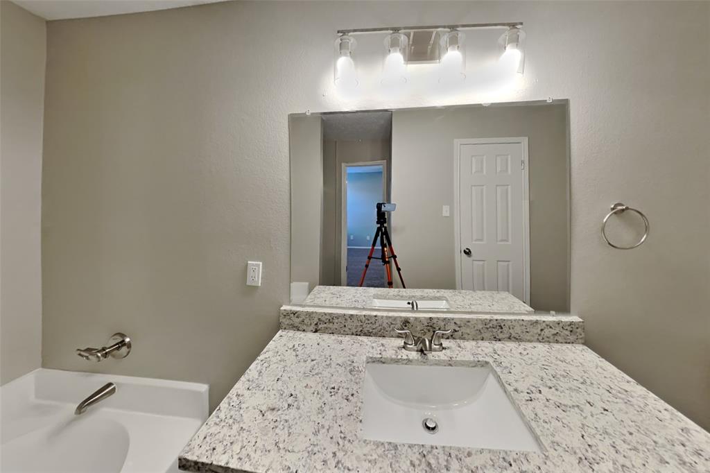 516 Bailey Street Saginaw, TX 76179 - Photo 11 of 19 a bathroom with a sink and a mirror