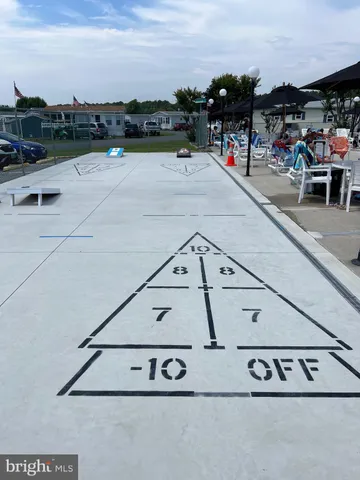 a view of a swimming pool with lawn chairs under an umbrella