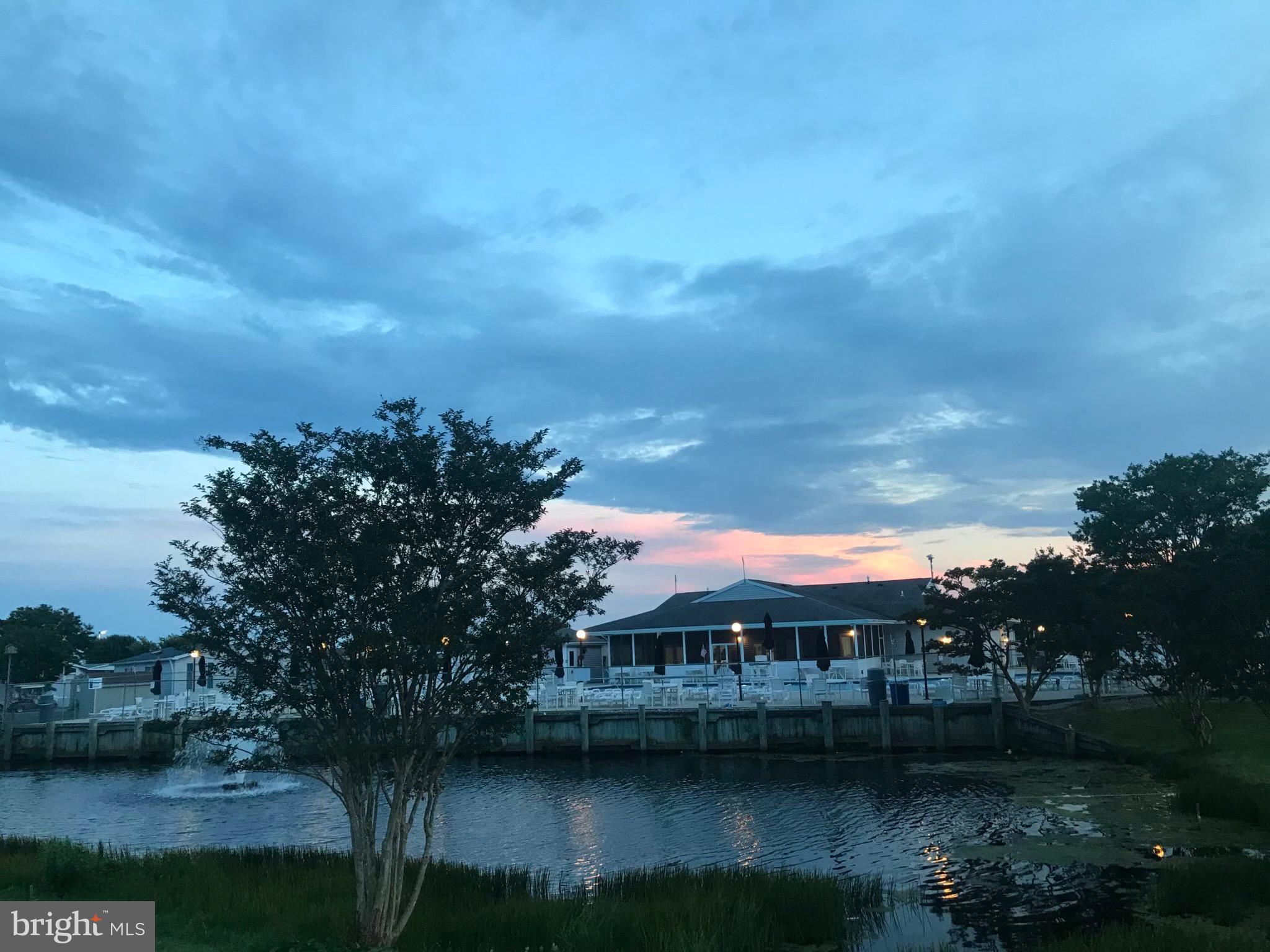 8339 Longboat Way South Berlin, MD 21811 - Photo 80 of 92 a view of a lake with a houses in the background
