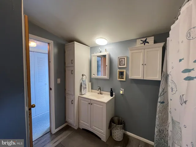 a view of entryway with wooden floor and a front door