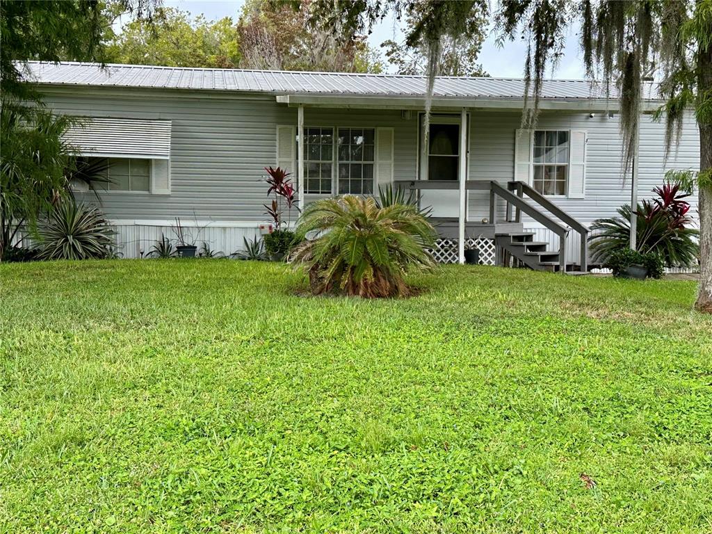 a view of a house with a yard porch and sitting area