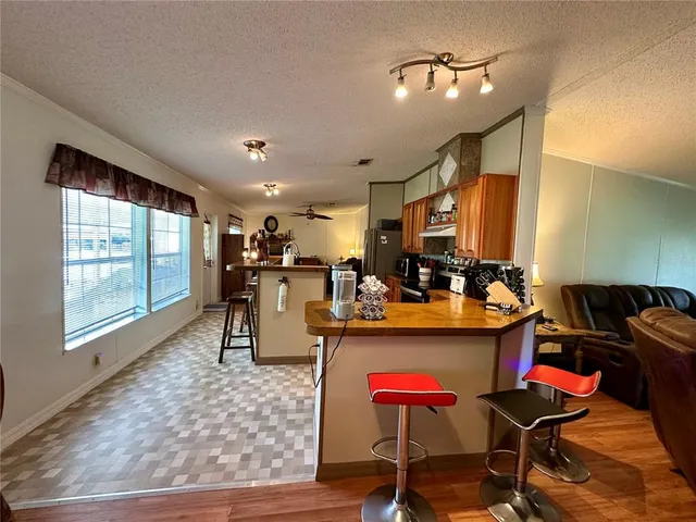 a living room with furniture a fireplace and a ceiling fan