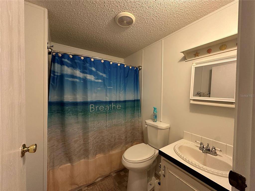 56233 Water Oak Road Astor, FL 32102 - Photo 18 of 50 a bathroom with a toilet sink and mirror