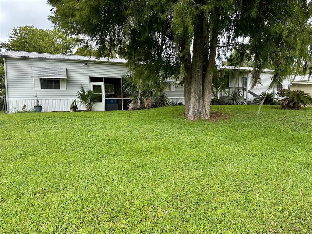 56233 Water Oak Road Astor, FL 32102 - Photo 31 of 50 a front view of a house with a garden