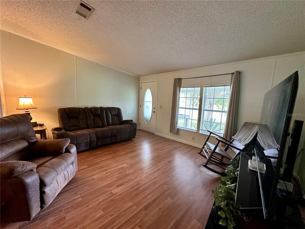 56233 Water Oak Road Astor, FL 32102 - Photo 5 of 50 a living room with furniture and a flat screen tv