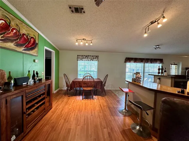 a kitchen with sink refrigerator and microwave